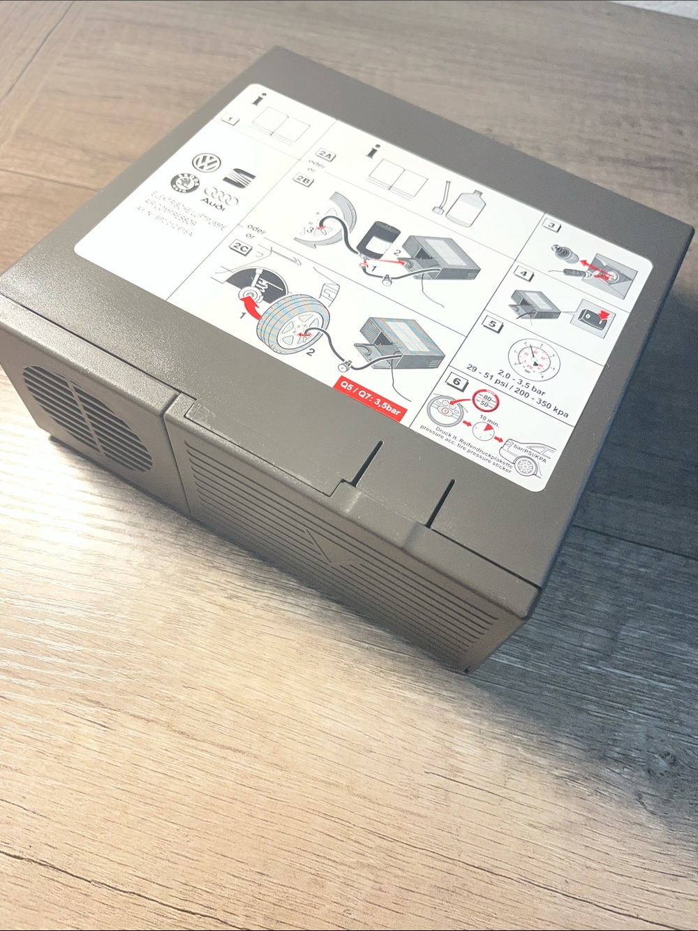 Compact Gray Vehicle Air Compressor with Instruction Panel